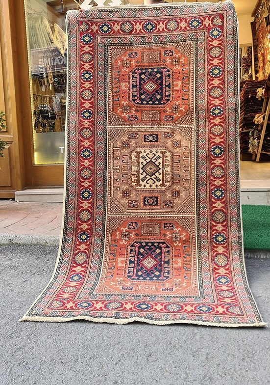 Mid-century Bunyan runner rug from Kayseri, Turkey, circa 1950, 3x7 ft Features three geometric medallions within square frames, surrounded by multi-layered floral borders. Handwoven with superior quality wool using natural dyes, this rug showcases traditional Turkish artistry, ideal for enhancing narrow spaces such as hallways, kitchens, or entryways with timeless elegance.