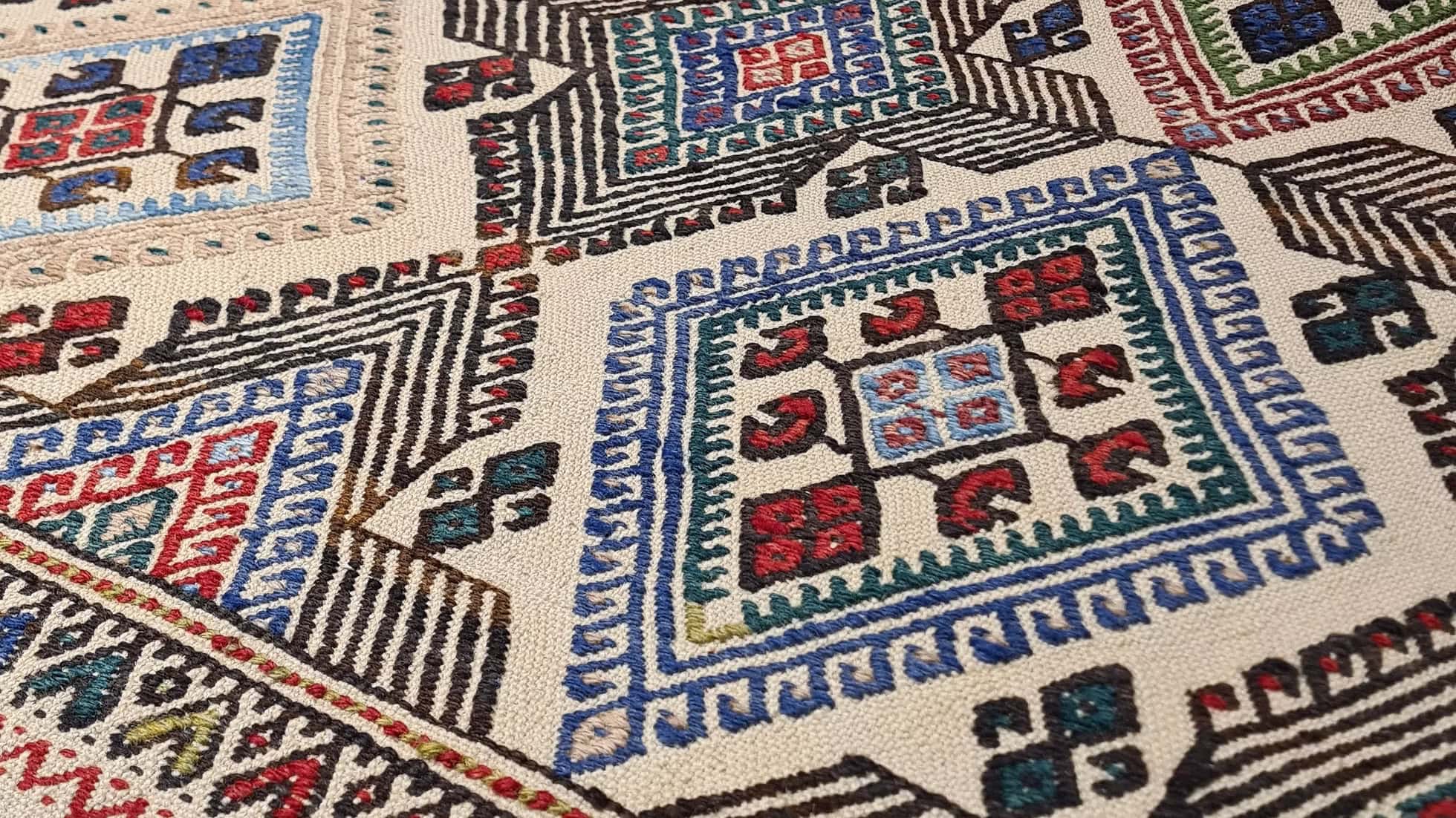 Handcrafted Anatolian Kilim rug featuring an intricate design and a time-softened palette of natural pigments—ideal for NYC interior designers seeking to anchor Soho lofts, Upper West Side residences, or Hamptons homes with timeless cultural heritage and artisanal charm.