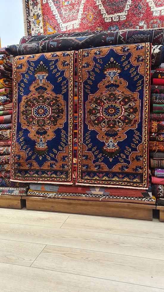 Exclusive two-piece Mid-Century Konya Oriental rug set measuring from Kilim Couture New York, handwoven in Konya, Turkey. Small accent 2x4 rugs in shades of rust, navy, mustard, and charcoal with detailed geometric medallions, perfect for luxury foyers, corridors, or high-end home decor.