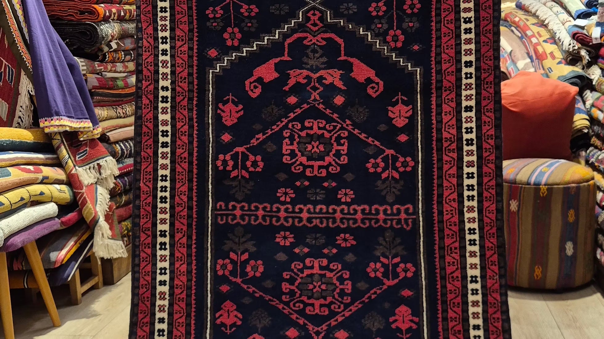 Vintage Yagcibedir Anatolian hand-knotted wool rug in inky blue, crimson madder, and aged oak, early–mid 20th century