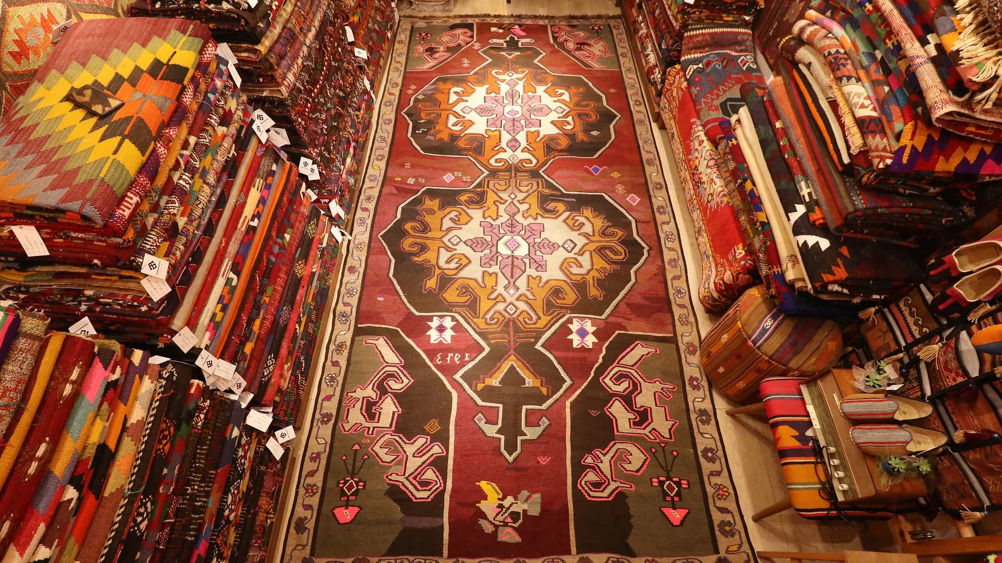 vintage handwoven runner rug with date signature and medallions in floral border