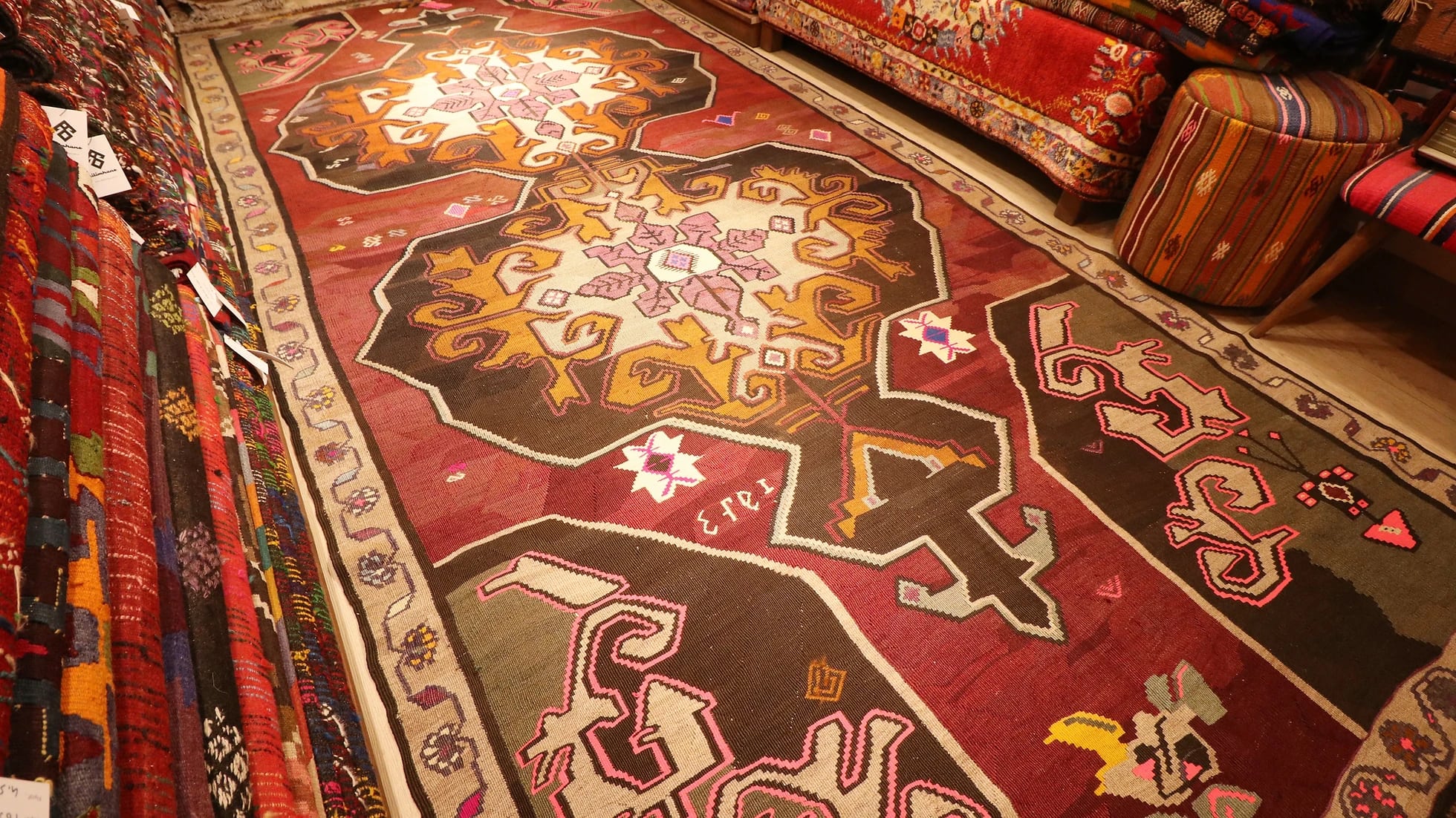 vintage handwoven runner rug with date signature and medallions in floral border