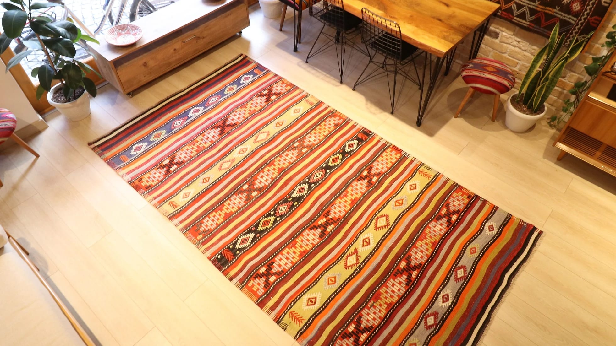 an old vintage handwoven Turkish runner rug in natural rustic hues and traditional stripe patterns