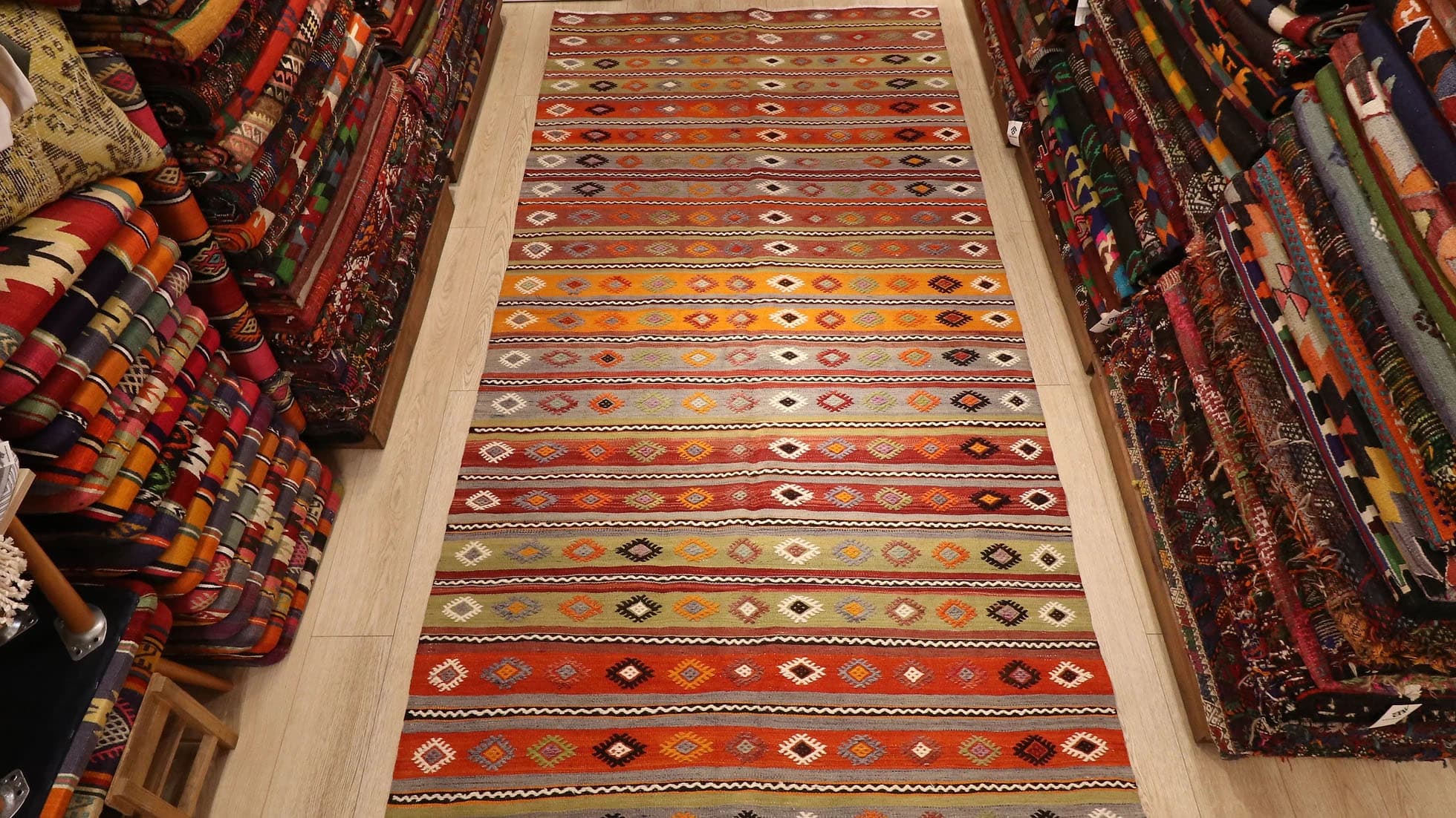 a majestic rustic Kurdish tribal runner rug in earth tones from mid-century by Kilim Couture