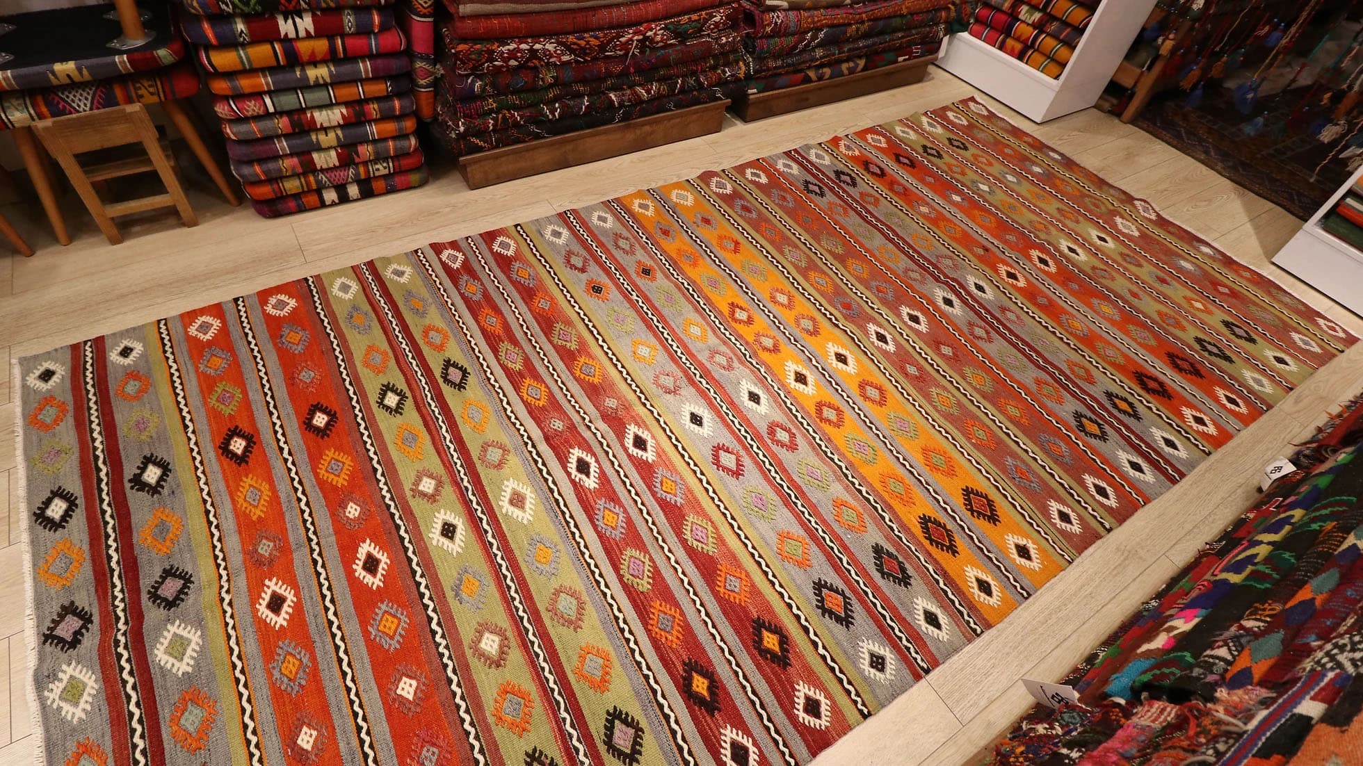 a majestic rustic Kurdish tribal runner rug in earth tones from mid-century by Kilim Couture