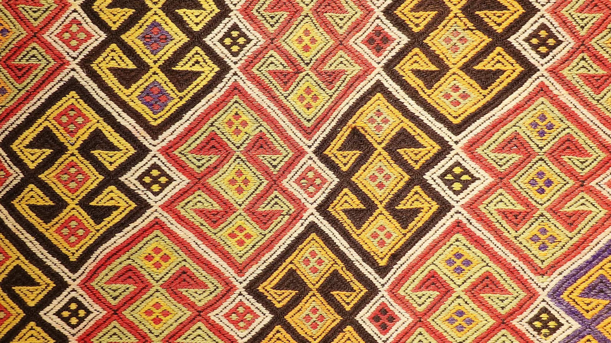 colorful handwoven oriental Turkish rug in wool featuring traditional tribal motifs from the mid-century