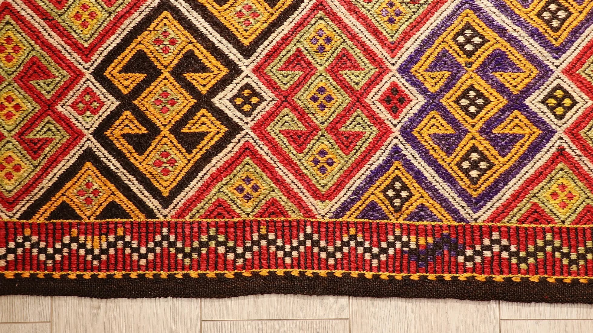 colorful handwoven oriental Turkish rug in wool featuring traditional tribal motifs from the mid-century