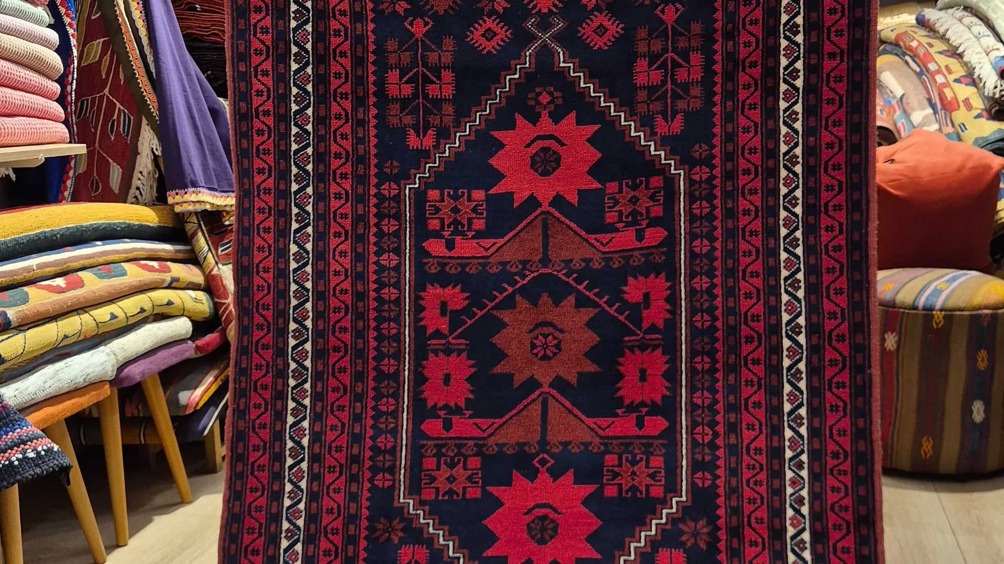 Early 20th century Turkish Yağcıbedir hand-knotted wool rug in deep indigo and cherry red, styled as an architectural accent rug