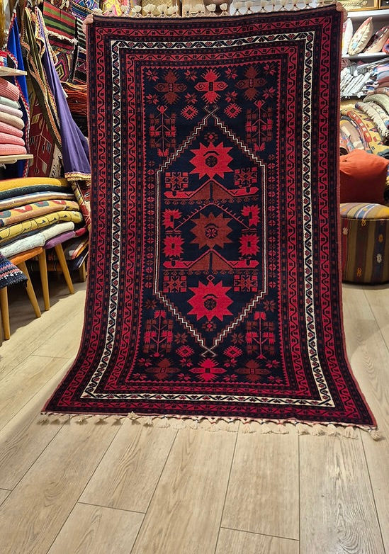 Early 20th century Turkish Yağcıbedir hand-knotted wool rug in deep indigo and cherry red, styled as an architectural accent rug