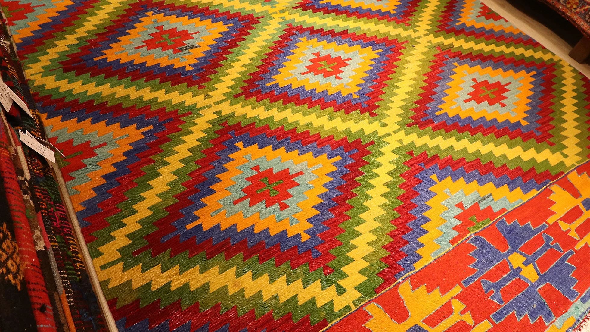 vibrant, vivid, and colorful vintage Turkish rug in geometric patterns woven sustainably in Denizli, Turkey