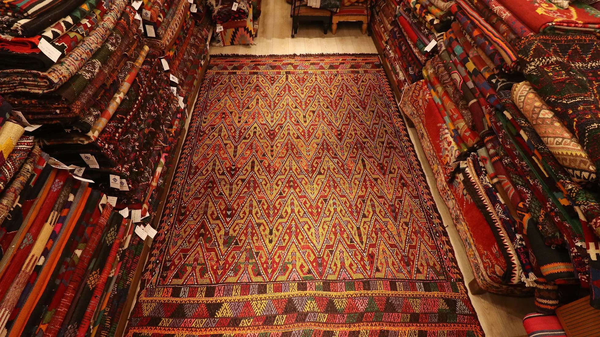 the perfect oriental Turkish rug in rustic colors and traditional hands on hips motifs by Kilim Couture New York rug gallery