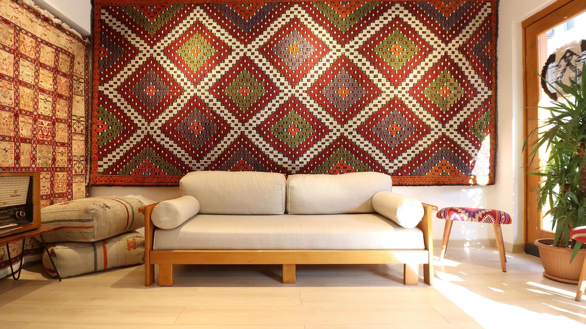 a majestic and true authentic mid-century cecim gallery runner rug is hanging on the wall as a tapestry gracefully in Kilim Couture New York rug showroom
