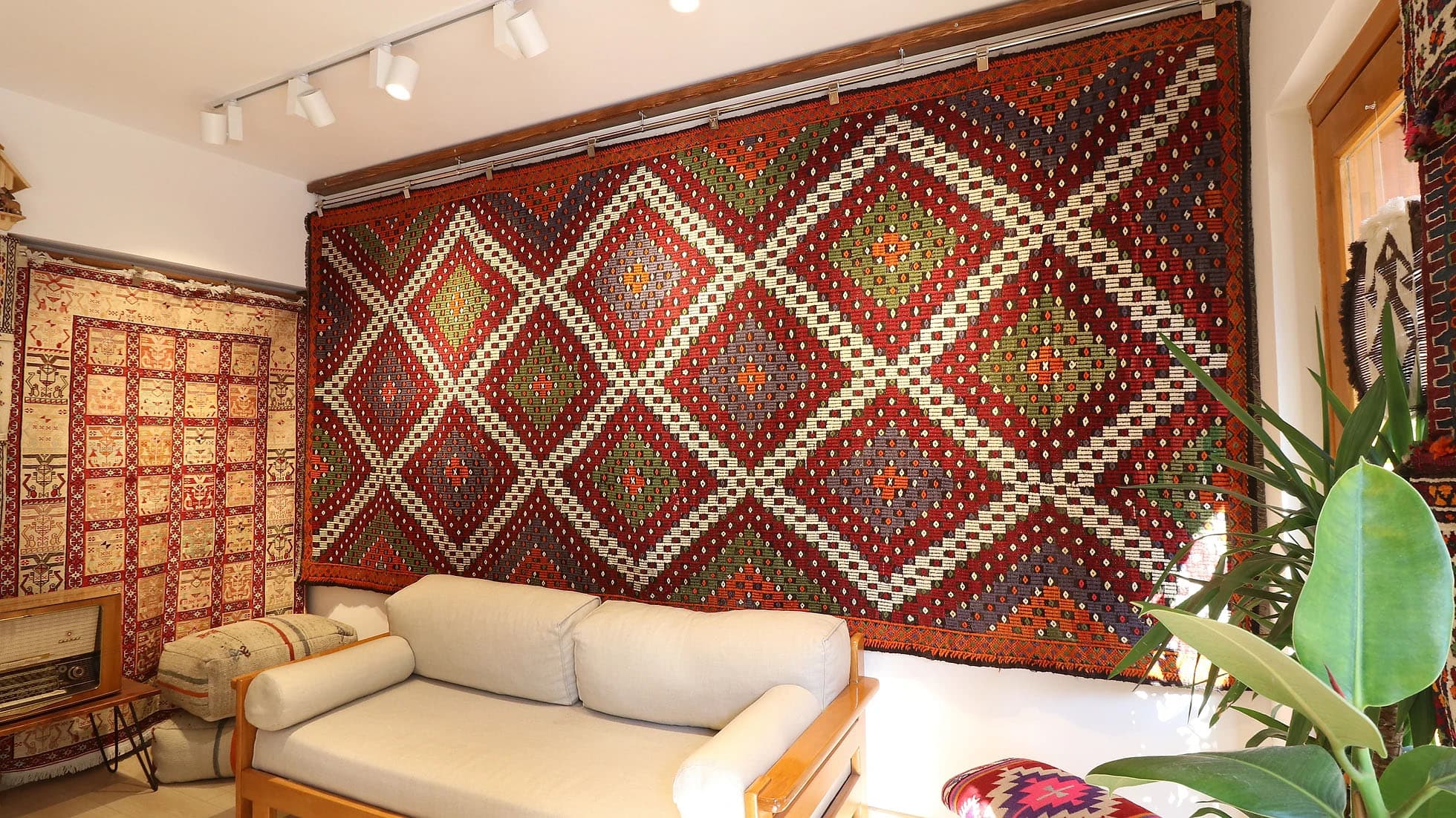 a majestic and true authentic mid-century cecim gallery runner rug is hanging on the wall as a tapestry gracefully in Kilim Couture New York rug showroom