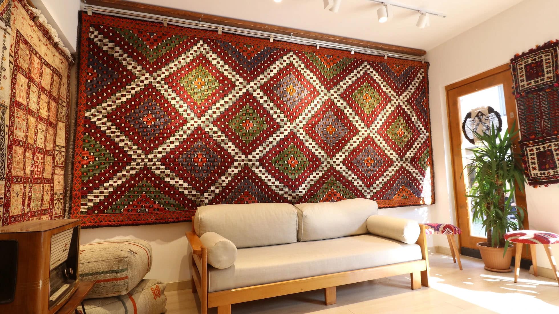 a majestic and true authentic mid-century cecim gallery runner rug is hanging on the wall as a tapestry gracefully in Kilim Couture New York rug showroom