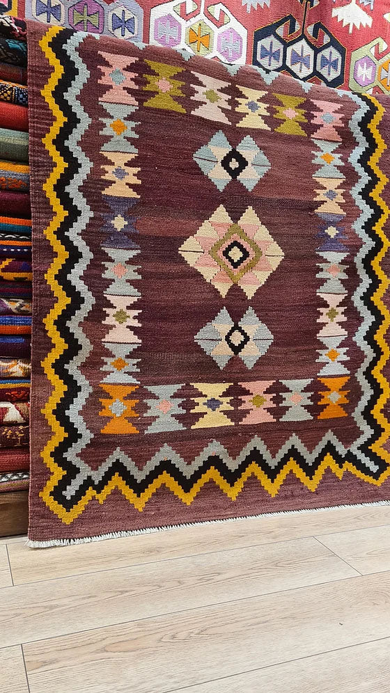 Vintage Handwoven Milas Kilim Rug, 4x5 ft, featuring a mocha mousse background with muted tones of rosewater pink, lavender mist, and tangerine peel. Adorned with intricate 'hair band' and 'running water' motifs, this artisan-crafted piece blends heritage and sophistication.