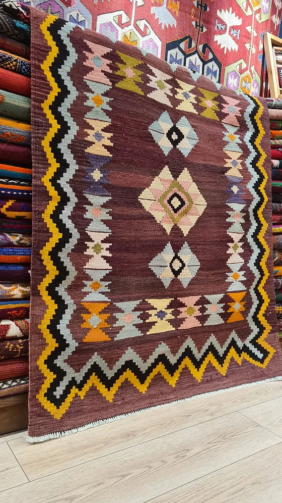 Vintage Handwoven Milas Kilim Rug, 4x5 ft, featuring a mocha mousse background with muted tones of rosewater pink, lavender mist, and tangerine peel. Adorned with intricate 'hair band' and 'running water' motifs, this artisan-crafted piece blends heritage and sophistication.