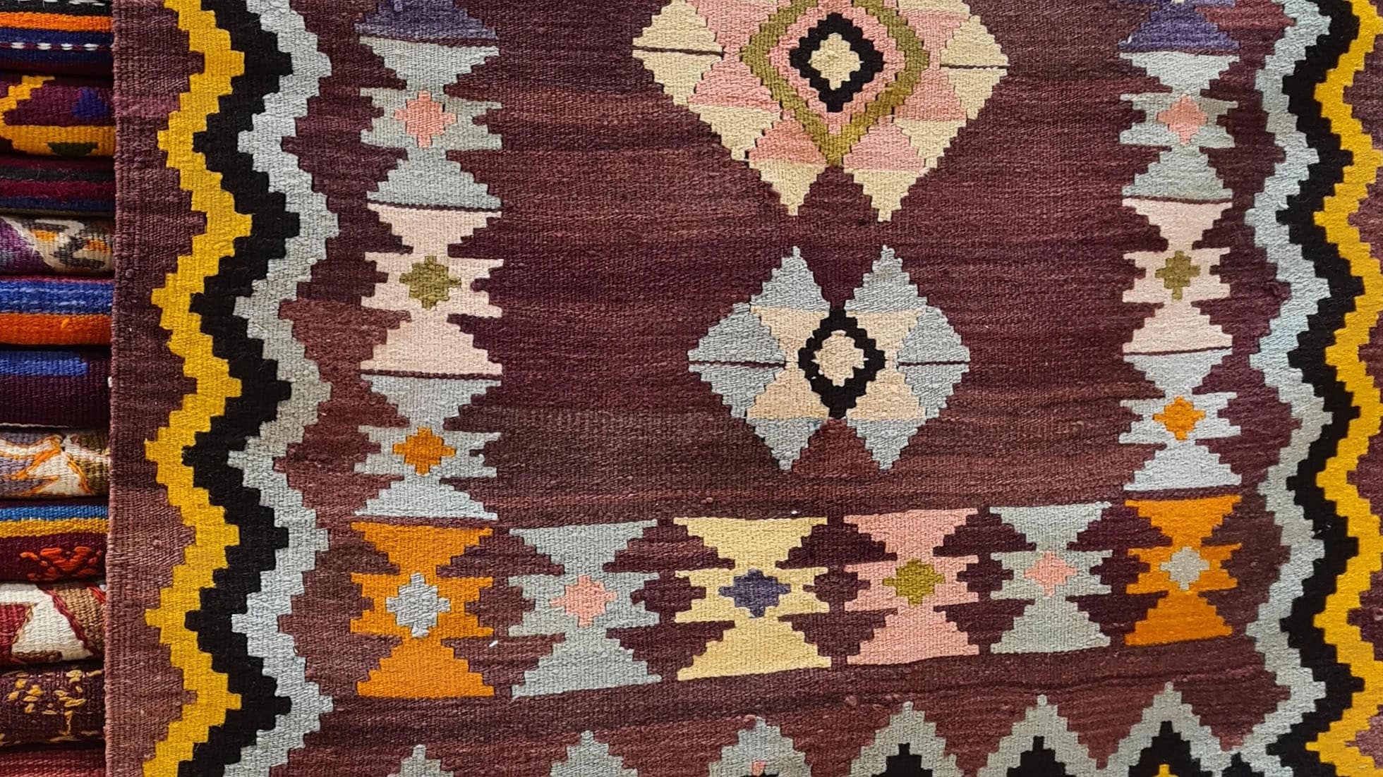 Vintage Handwoven Milas Kilim Rug, 4x5 ft, featuring a mocha mousse background with muted tones of rosewater pink, lavender mist, and tangerine peel. Adorned with intricate 'hair band' and 'running water' motifs, this artisan-crafted piece blends heritage and sophistication.