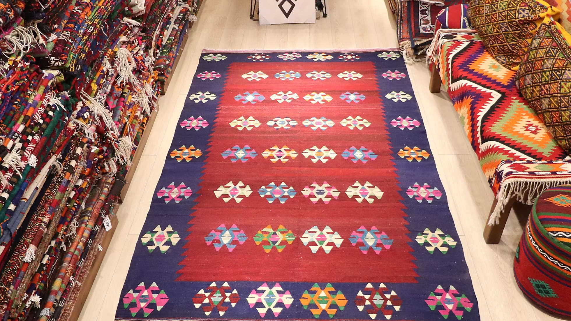 Wide-angle shot of the 1960s Turkish wool rug adding warmth and cultural depth to an eclectic interior design.