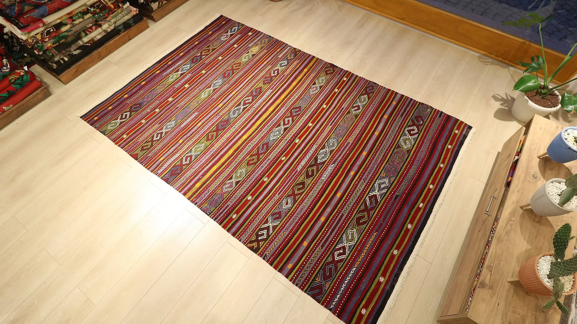 Full shot of vintage Turkish Balikesir kilim 6x9, with eclectic geometric stripe patterns and a harmonious blend of earth tones, including rust and slate blue, perfect for a sophisticated interior.