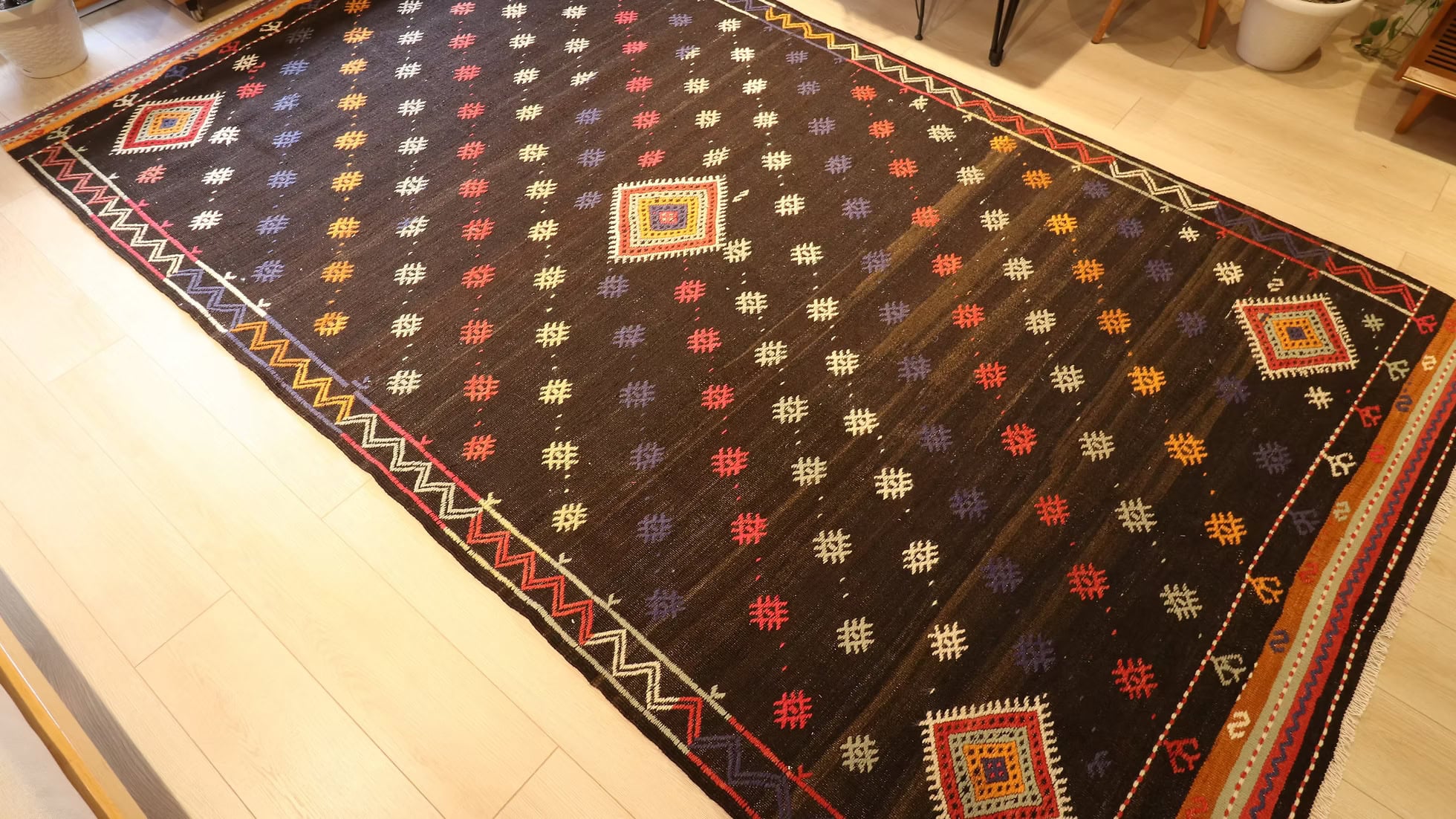 Wool flat-weave Kilim Couture rug styled in a modern interior, showcasing its muted palette and artisanal nomadic craftsmanship.