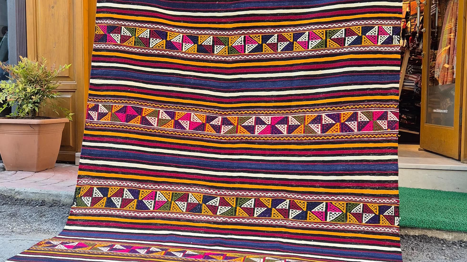 Vintage colorful striped 6x9 area rug, a classic example of Turkish textile artistry.