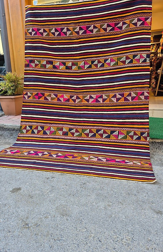 Authentic Turkish textile kilim rug with bold multicolor stripes, perfect for interior designers.
