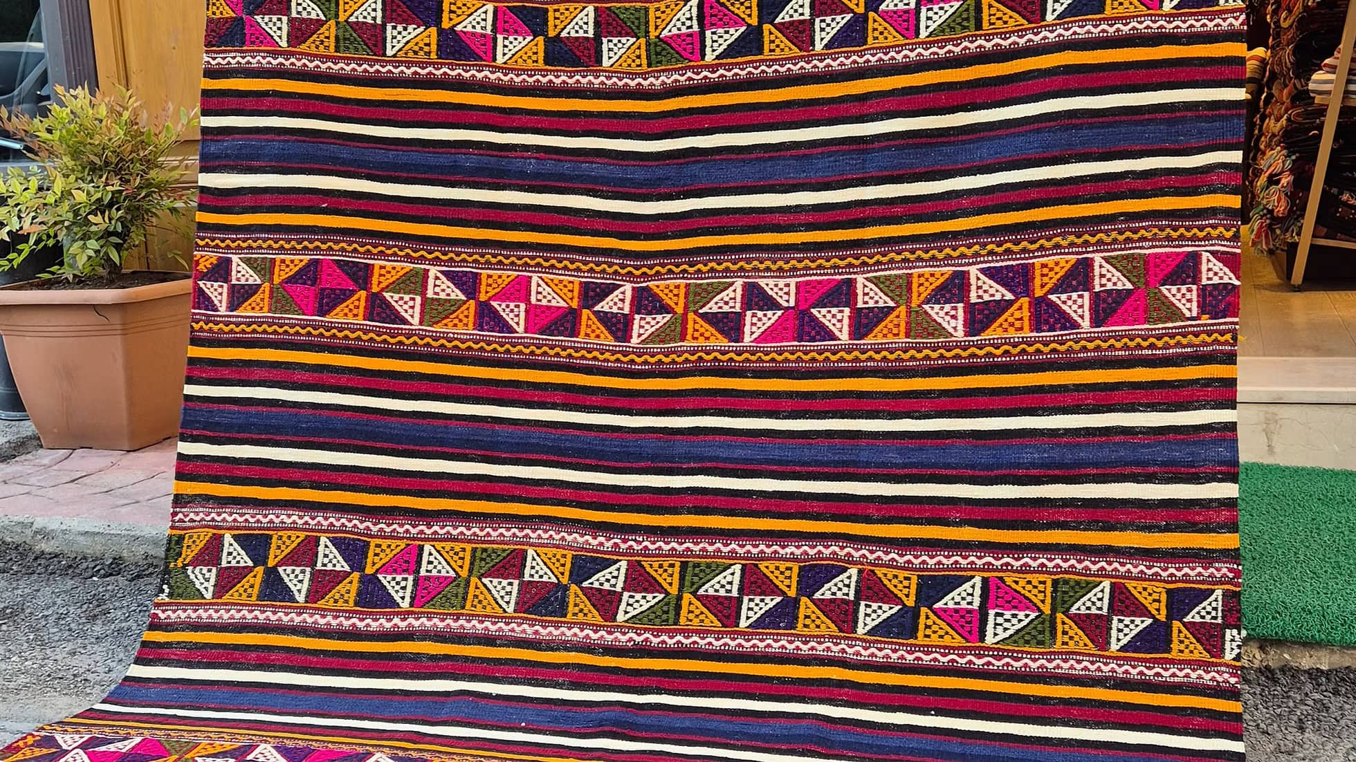 Authentic Turkish textile kilim rug with bold multicolor stripes, perfect for interior designers.