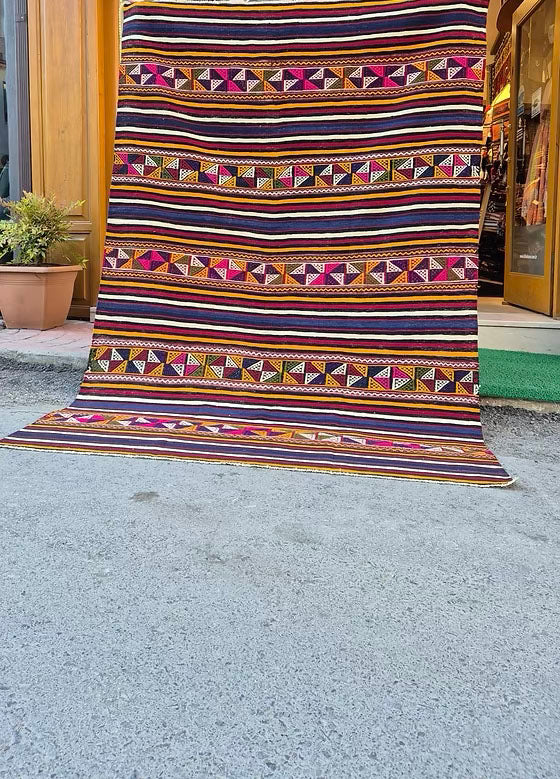 Vintage colorful striped 6x9 area rug, a classic example of Turkish textile artistry.