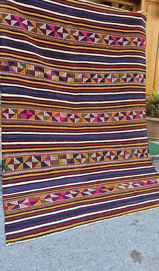 Close-up of a Turkish textile multicolor striped kilim rug highlighting traditional craftsmanship.