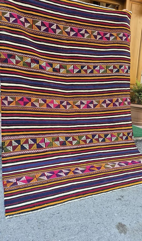 Close-up of a Turkish textile multicolor striped kilim rug highlighting traditional craftsmanship.