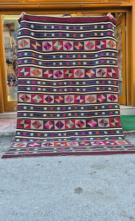 Rustic Turkish kilim rug, 5x8 ft, with a rich palette of midnight indigo, maroon plum, and ivory.