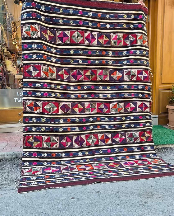 Handwoven 1960s Turkish kilim rug, 5x8 ft, adorned with rare vertical tassels and geometric patterns by Kilim Couture New York Rug Store NYC.