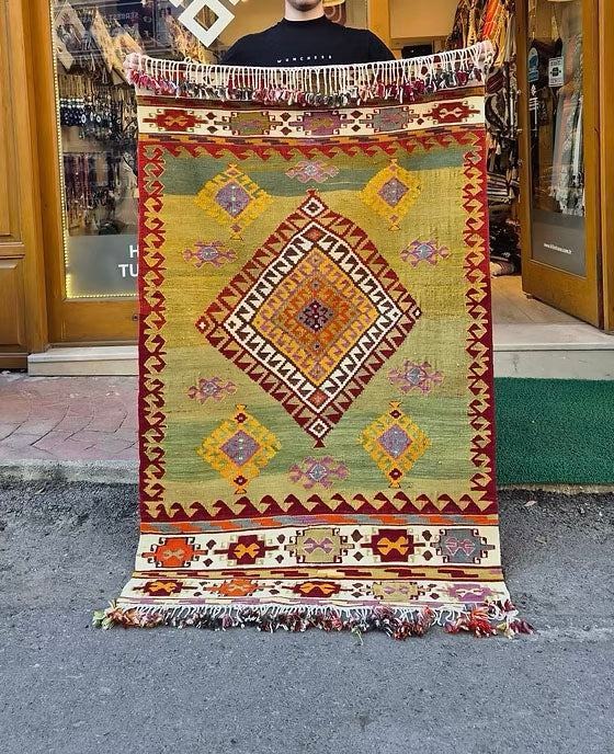 Vintage Turkish Aegean handwoven kilim in pastel pistachio, golden ochre, and soft mauve for luxury interiors