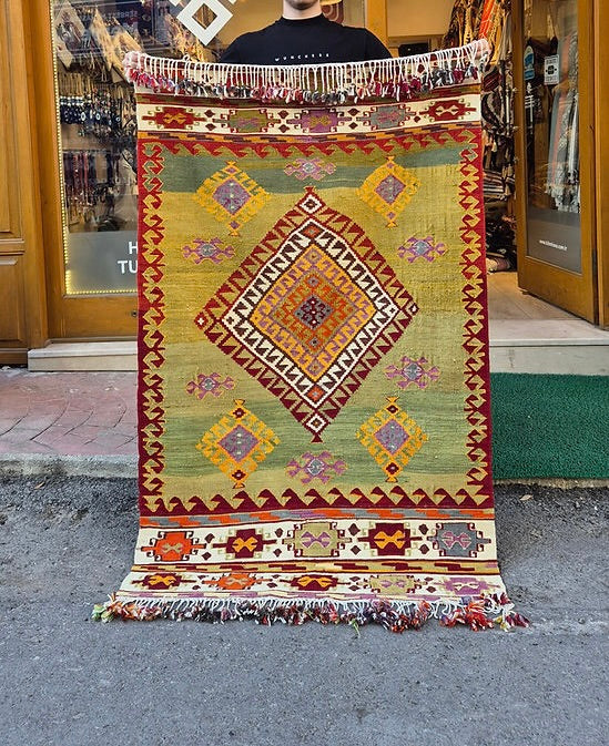 Vintage Turkish Aegean handwoven kilim in pastel pistachio, golden ochre, and soft mauve for luxury interiors