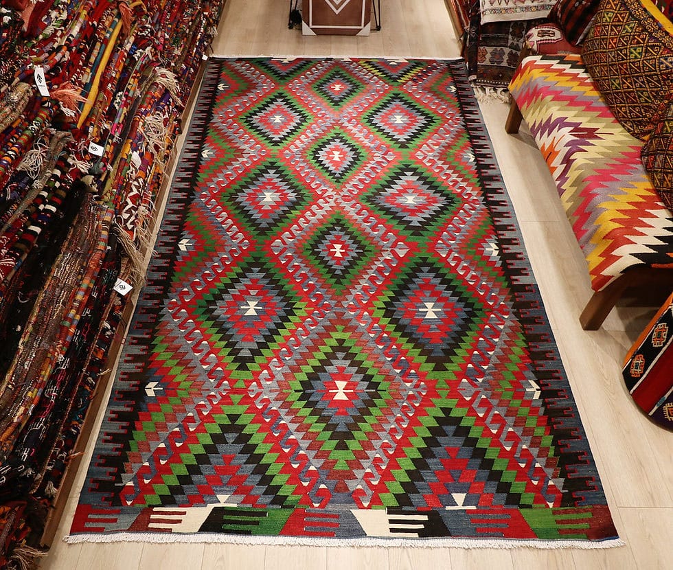 Vintage Turkish Denizli Kilim. This rare 1950s handwoven kilim from Denizli, Turkey, features a striking royal crimson backdrop with intricate 'comb' border motifs in onyx truffle and smoky gray. Measuring 6x10, its bold lozenge pattern embodies the rich craftsmanship of Anatolian weaving. A timeless fusion of history and elegance, this versatile heirloom rug adds warmth and sophistication to any space.