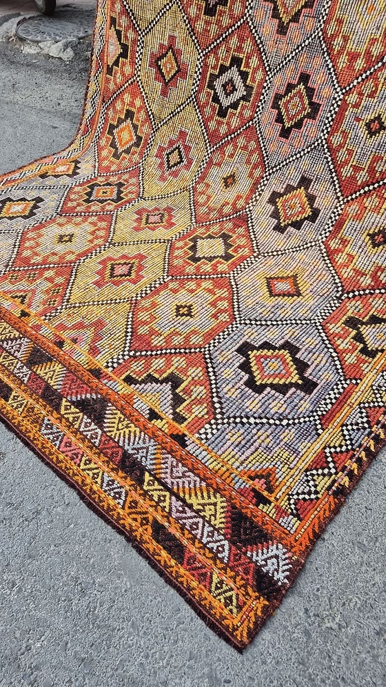 Close-up of a vintage Turkish Cecim kilim Rug in terracotta and denim tones—ideal for farmhouse interiors with rustic character.