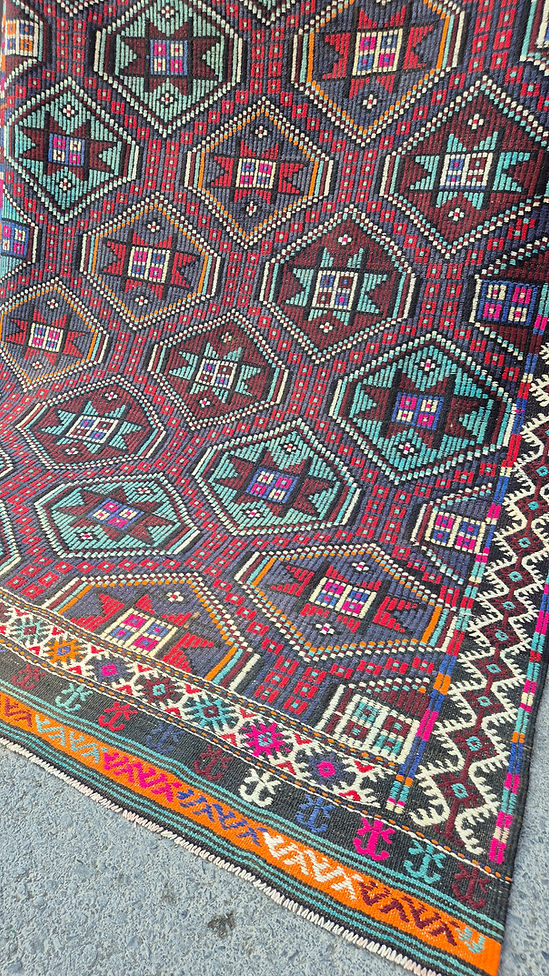 Close-up of a colorful geometric patterned Turkish tribal quilt rug