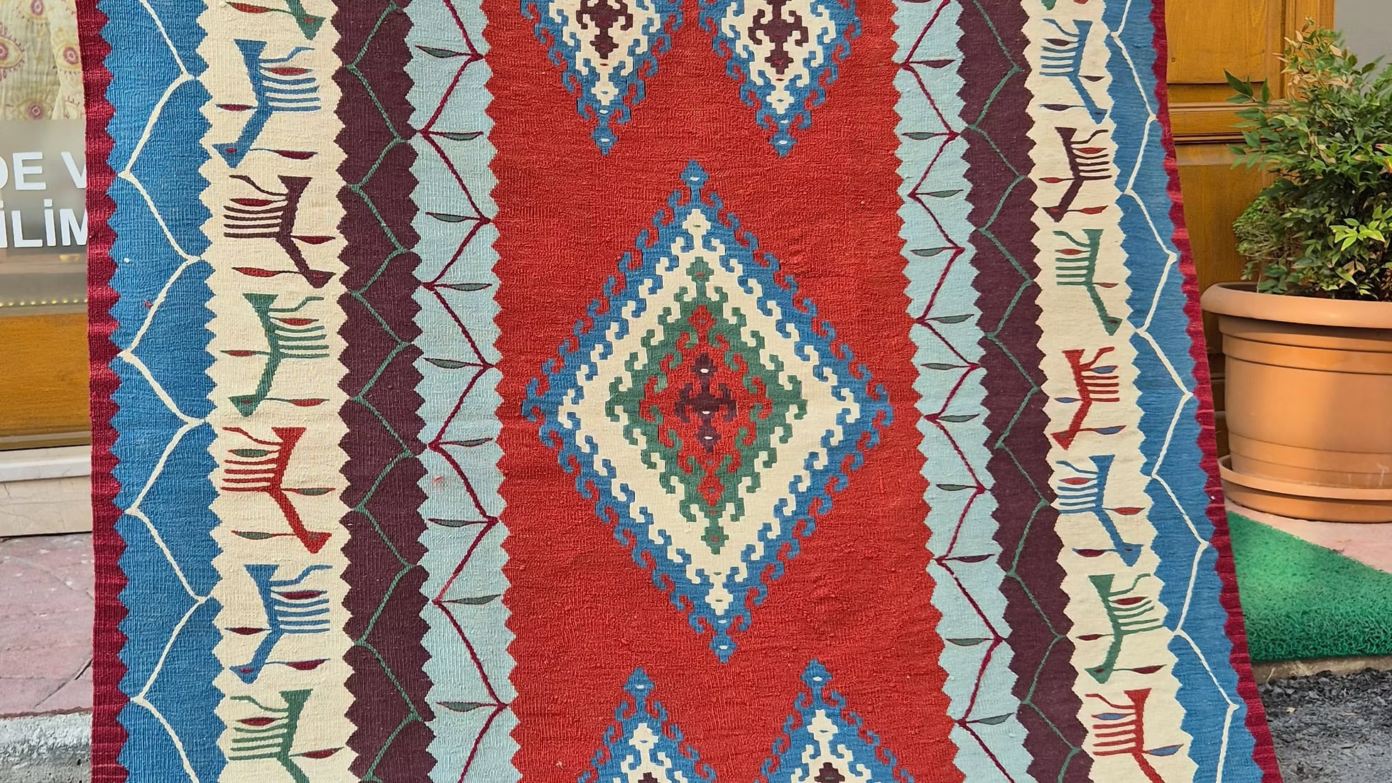 1980s Usak Anatolian accent rug featuring symbolic motifs and geometric patterns