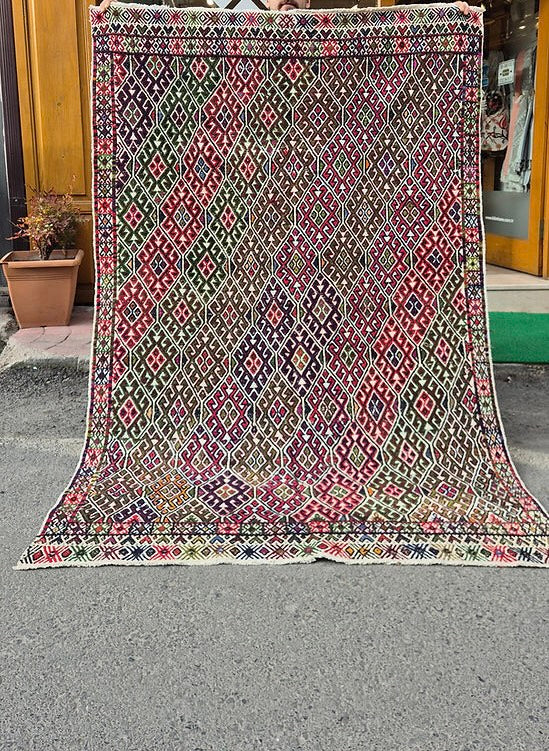 Vintage Turkish handwoven cecim kilim rug with raised tribal motifs on ivory ground by Kilim Couture New York