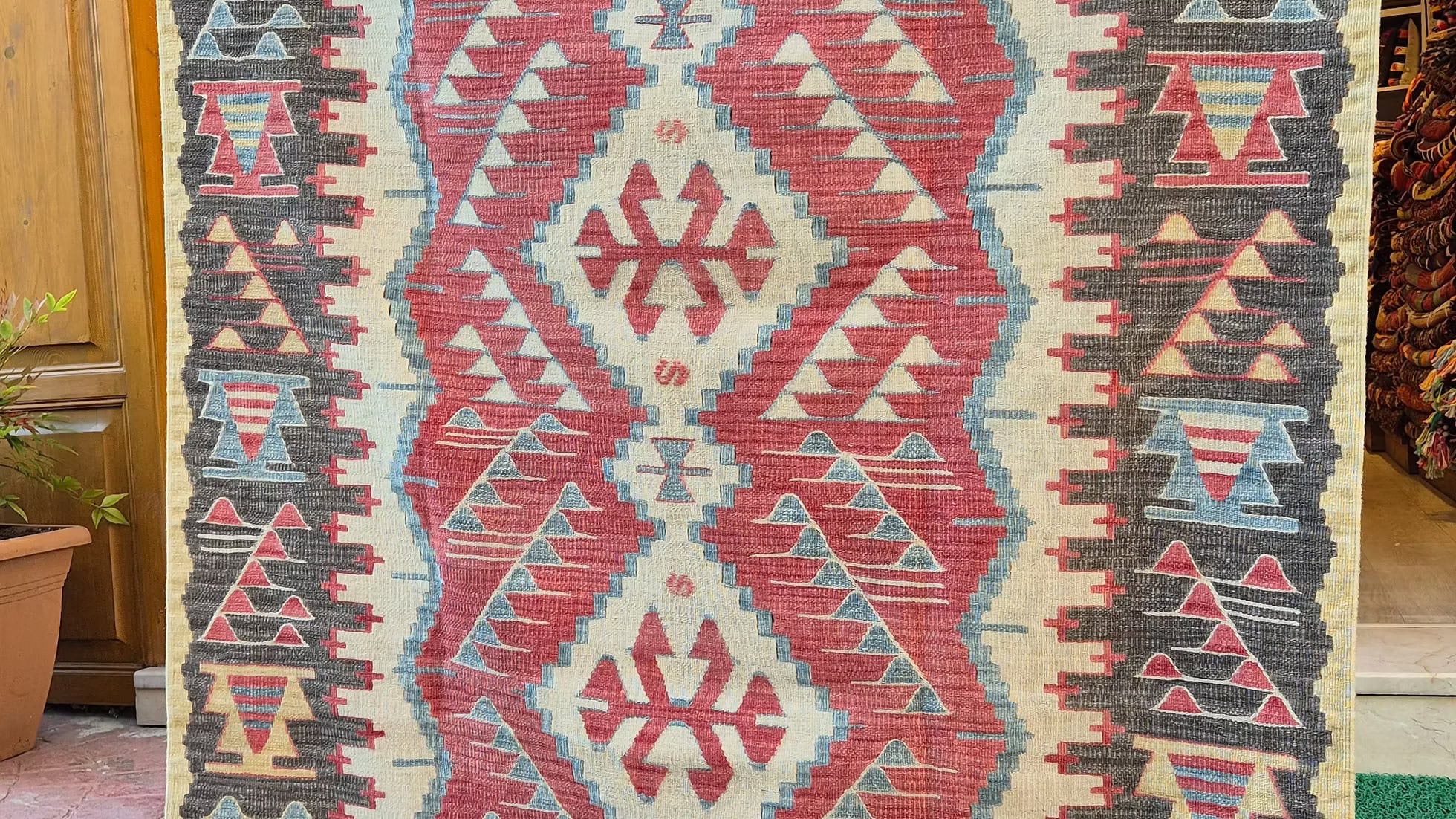 Vintage Turkish Oushak kilim with warm earthy tones and geometric Southwestern patterns, perfect for boho, modern rustic, or curated designer interiors.