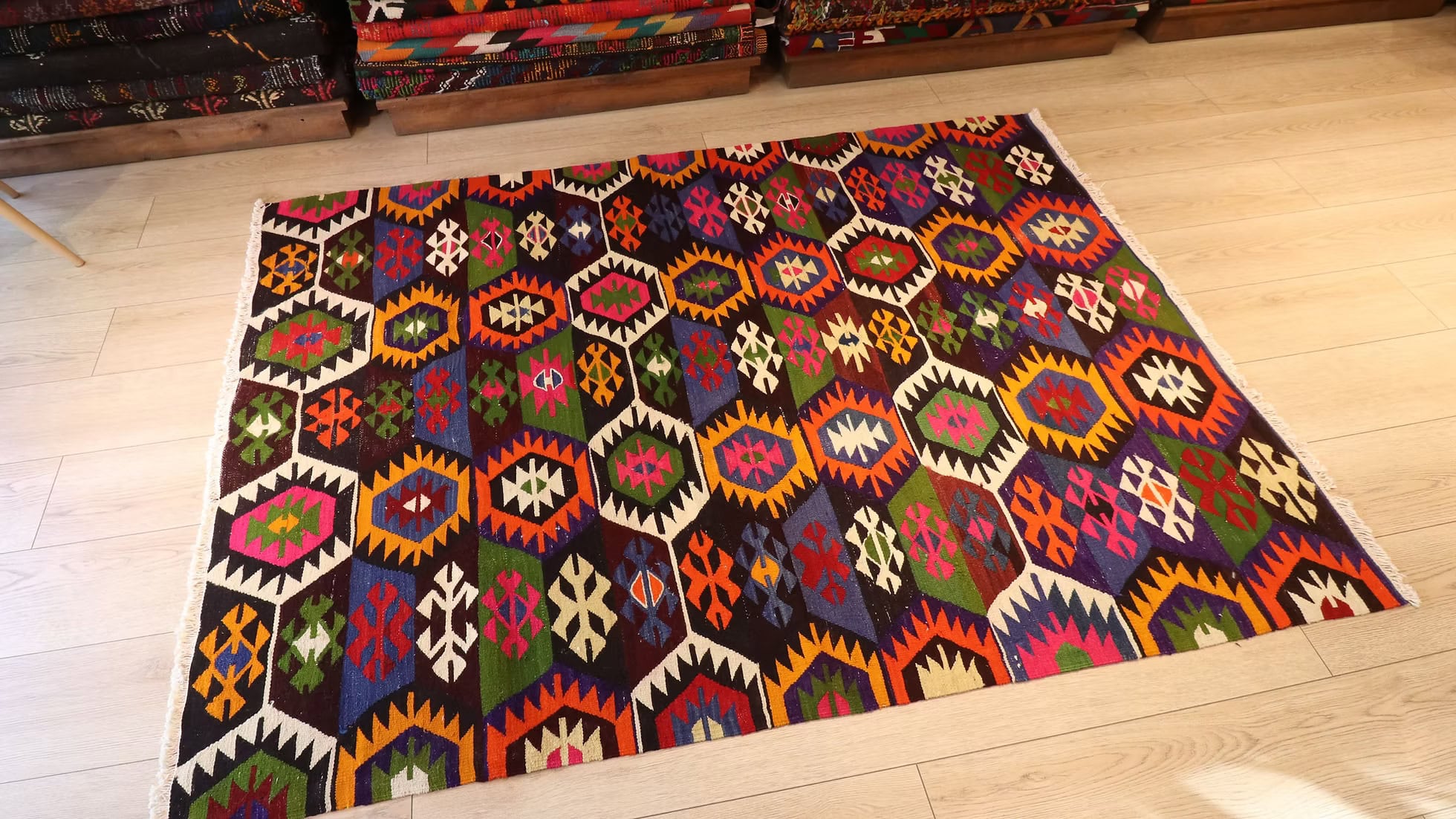 Vintage 5x7 ft Turkish kilim from Tavas, Denizli, woven with sustainable wool and intricate lozenge motifs. A stunning combination of vibrant and earthy tones, accented with handcrafted tassels and a rich Anatolian heritage.