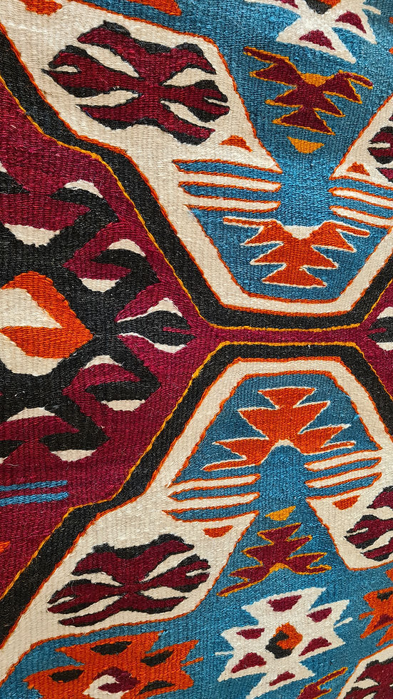 With deep roots in Anatolian tradition and a nod to Southern sensibility, this kilim with bold medallions and protective 'wolf's mouth' motifs blends perfectly into a NYC apartment, Southern ranch, or Spanish-style villa, offering timeless elegance and storytelling.