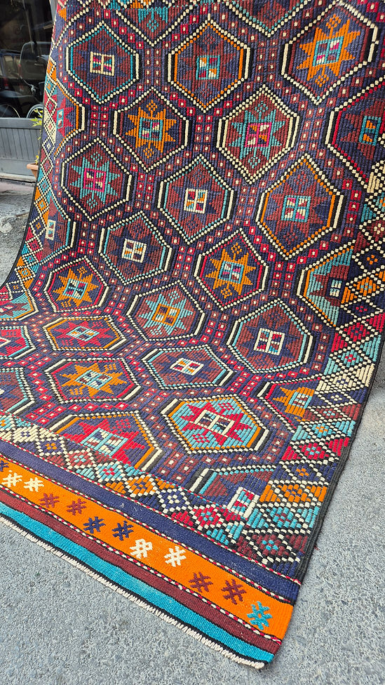 Mid-century modern vintage kilim rug with geometric star patterns and rich texture, ideal for curated layered interiors and maximalist living rooms