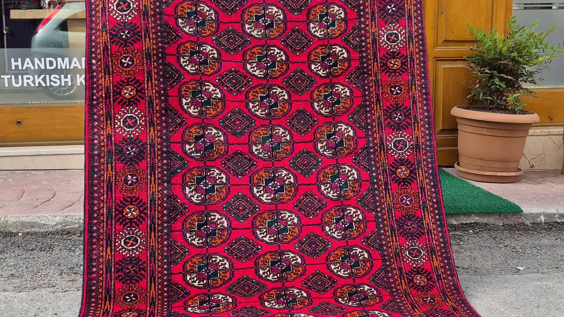 Authentic Bokhara medium size area rug in saturated crimson, designed for elegant luxury interior design projects.