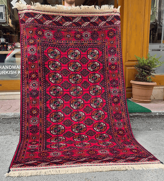 Luxury handwoven Turkmen Bokhara rug in saturated crimson, designed for elegant Brooklyn, NYC, and Hamptons homes