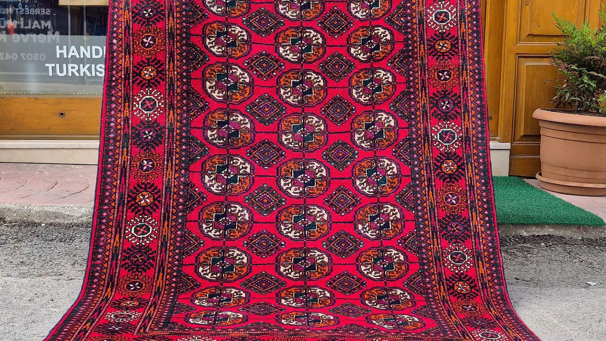 Turkmen Bokhara rug with gul medallion motif in crimson carmine, 4x6.9 ft, hand-knotted wool for luxury interiors