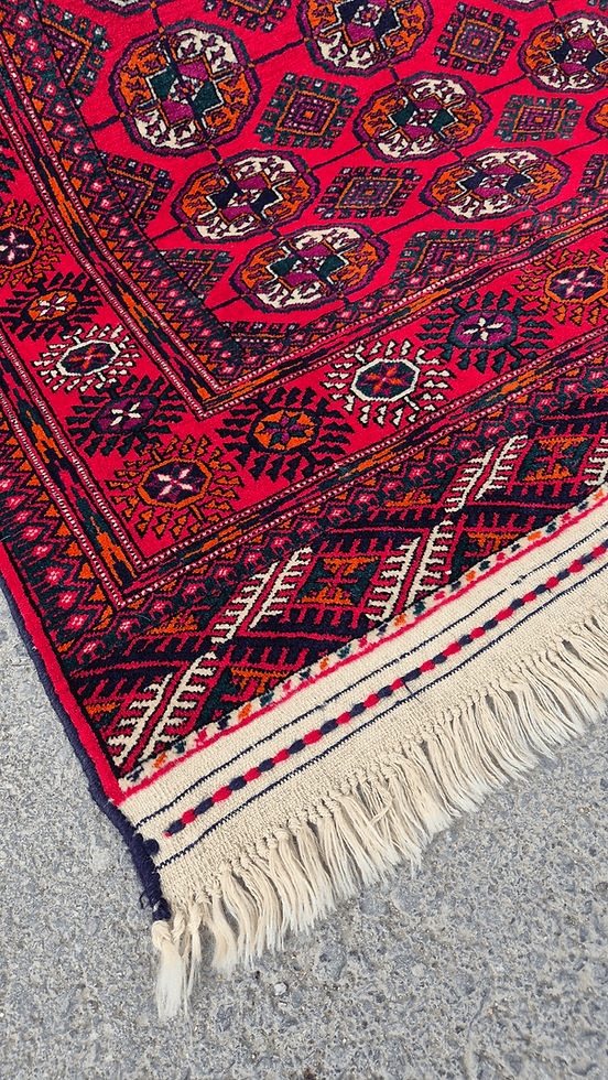 Vibrant hand-knotted Bokhara rug with symmetrical gul patterns, ideal for classic or bohemian living spaces