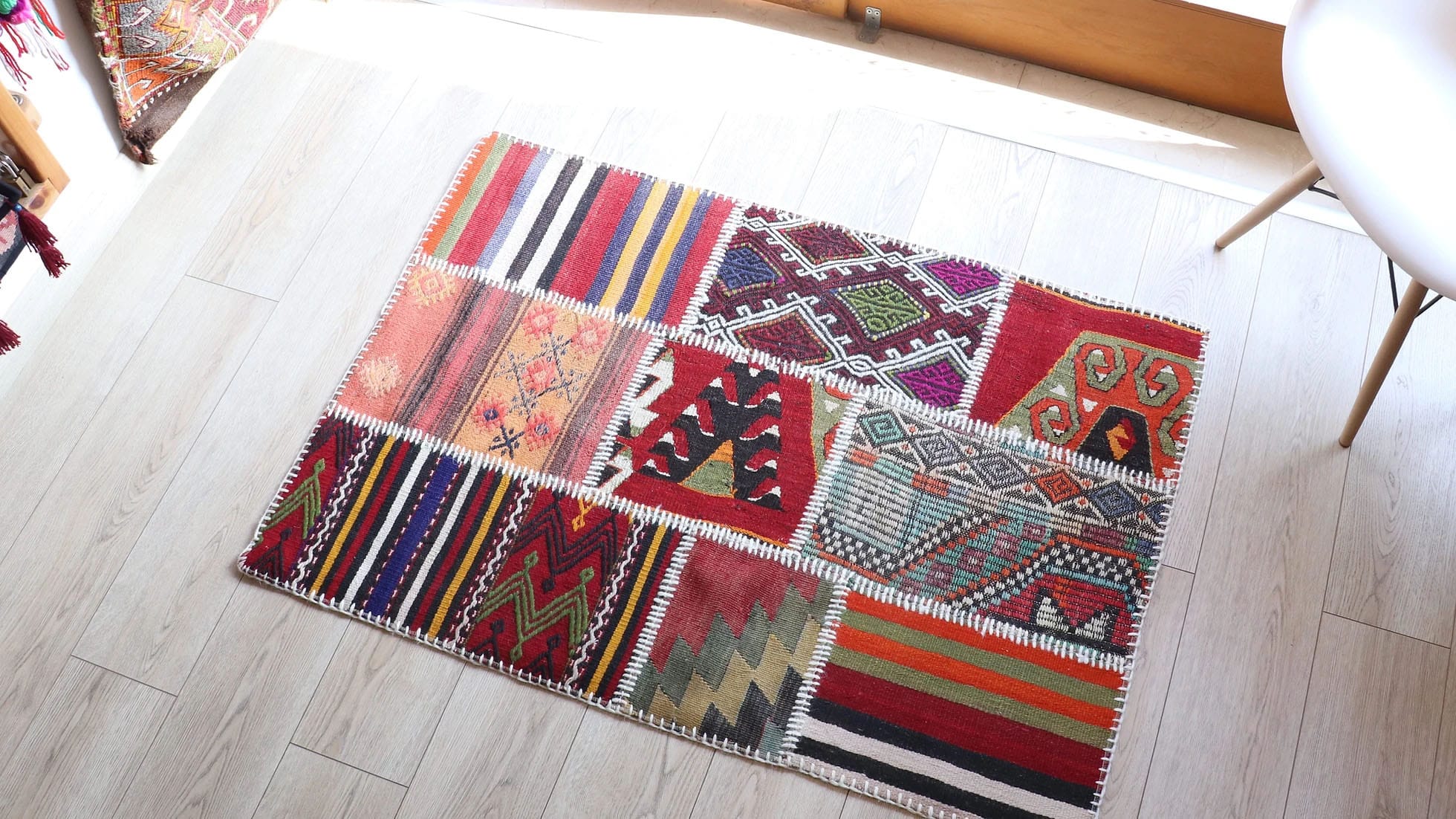 antique Turkish tribal small kilim rug in colorful stripes and traditional motifs