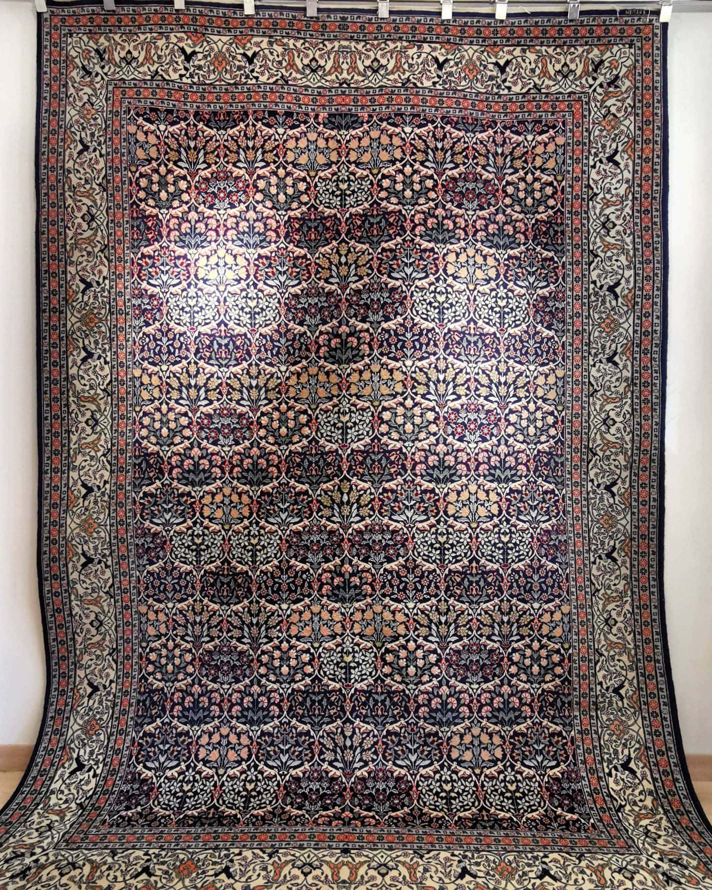luxury fine antique Turkish Hereke silk rug in pastel, earthy, and neutral floral motifs and patterns