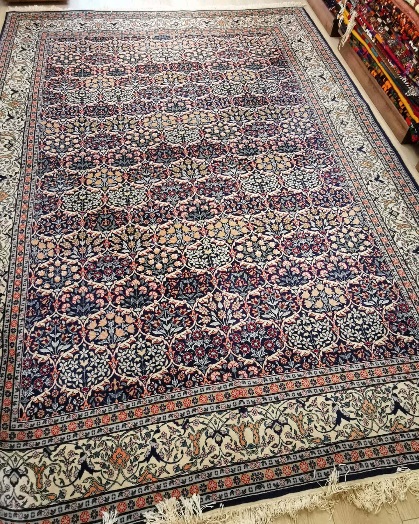 luxury fine antique Turkish Hereke silk carpet in pastel, earthy, and neutral floral motifs and patterns